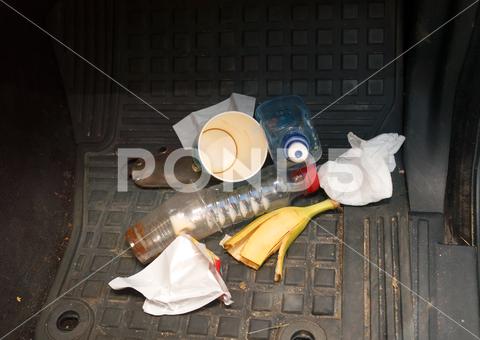 A car floor covered with trash and food leftover car, floor, carpet, trash, dirty, rubbish, closeup, dirty, unhygienic, travel, nobody, disorder, drinks, plastic, cups, bottles, disposable, food, leftover, untidy, lifestyle, background, vehicle, hygiene, inside