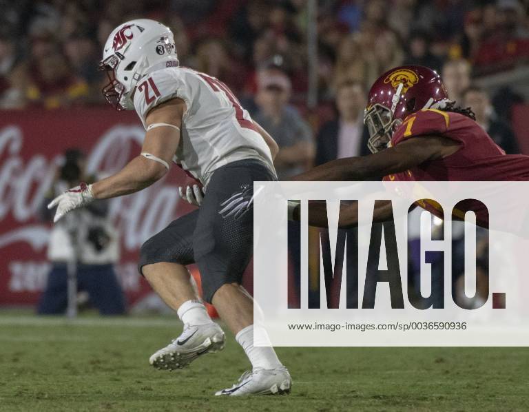 Los Angeles, California, U.S - Washington State s running back Max Borghi (21) escapes the grasp of USC s safety Marvell Tell III (7) during the first half against Washington State at the Los Angeles Coliseum on September 21, 2018 NCAA College League USA Footbal 2018: USC : Washington State - ZUMAg199 20180921_zap_g199_016