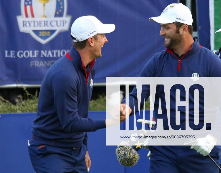 Justin Rose (L) congratulates Jon Rahm after his opening shot on the first tee at the start of the Ryder Cup at Le Golf National in Guyancourt near Paris on September 28, 2018. Team USA will compete against Team Europe in the three-day tournament. PAR20180928084 DAVIDxSILPA