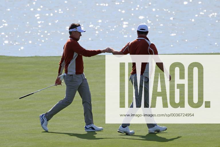 Ian Poulter (L) fist bumps teammate Jon Rahm on the 15th green on day two of the Ryder Cup at Le Golf National in Guyancourt near Paris on September 29, 2018. Poulter and Rahm lost their match to Jordan Spieth and Justin Thomas 2 & 1. PAR20180929026 DAVIDxSILPA