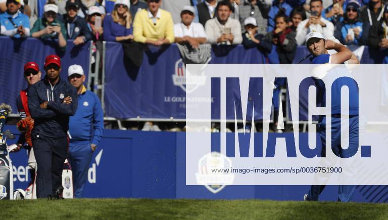 Spanish golfer Jon Rahn (R) shoots at tee 1 as US Tiger Woods (L) looks on during the final day of the Ryder Cup 2018 at The Golf National in Guyancourt, near Paris, France, 30 September 2018. Ryder Cup 2018 - Europe vs USA !ACHTUNG: NUR REDAKTIONELLE NUTZUNG!