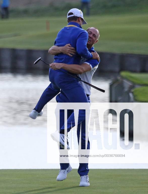 Alex Noren (R) and Thorbjorn Olesen celebrate after Noren made a long putt on the 18th hole at the Ryder Cup at Le Golf National in Guyancourt near Paris on September 30, 2018. Team Europe defeated Team USA 17.5 to 10.5 to hand the Americans their sixth straight loss on foreign soil. PAR20180930063 DAVIDxSILPA