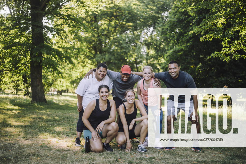 Portrait of happy multiracial male and female friends posing after training session at park Sweden, Stockholm, model released