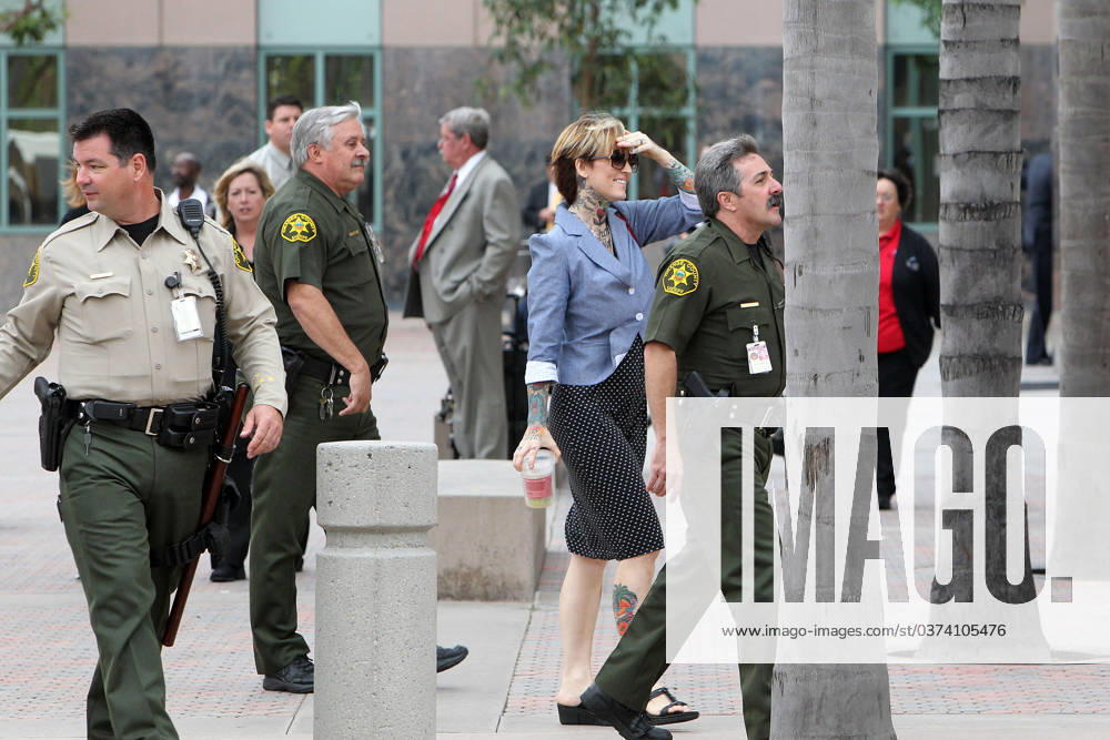 Janine Lindemulder is all smiles as she leaves court for the second time of the day after allegedly attacking a paparazzo 46442, ORANGE, CALIFORNIA - Thursday October 21, 2010. Janine Lindemulder is all smiles as she leaves court for the second time of the day surrounded by a large police escort. Police questioned the former wife of Jesse James after Janine allegedly attacked a paparazzi videographer who was filming her leaving court following her child custody hearing at the Orange County Court. A police officer said they would file their report on the incident and no arrests were made. , Credit:James Breeden, PacificCoastNews.com