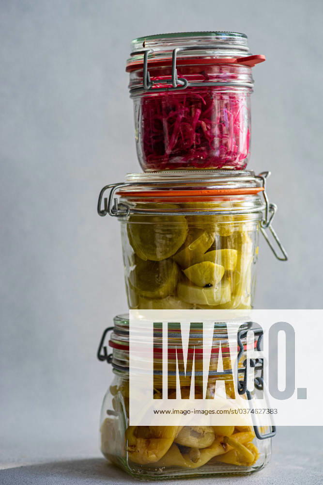 IMAGO Creative, Food, Pickled Onions IMAGO Creative, Food, Trend, Meal Prep Three glass jars stacked atop each other, filled with fermented vegetables: red cabbage with beetroot, spicy peppers, and white cucumbers, showcasing a variety of vibrant colors and textures. Model Released AnnaBogush_ID18226_545510_006