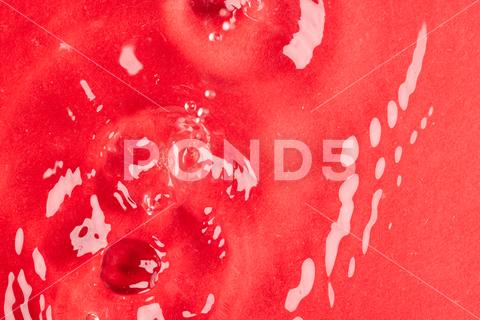 Close up of water drop falling into water with ripples and copy space on red background. Water, liquid and colour concept. No People Close Water Drop Falling Water Ripple Copy Space Red Background Liquid Colour Concept Drop Splash Abstract Design Background Wet Flow Fluid Closeup Wave Illustration Macro Business Graphic Symbol Isolated Flowing Color Drink Clean Water Falling Copy Space Red