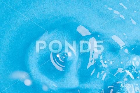 Close up of water drop falling into water with ripples and copy space on blue background. Water, liquid and colour concept. No People Close Water Drop Falling Water Ripple Copy Space Blue Background Liquid Colour Concept Drop Splash Abstract Design Background Wet Flow Fluid Closeup Wave Illustration Macro Business Graphic Symbol Isolated Flowing Color Clean Drink Water Falling Copy Space Blue