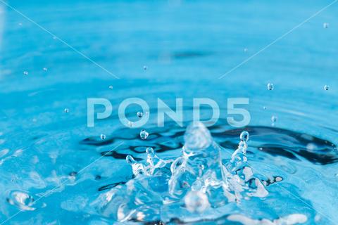 Close up of water drop falling into water with ripples and copy space on blue background. Water, liquid and colour concept. No People Close Water Drop Falling Water Ripple Copy Space Blue Background Liquid Colour Concept Drop Splash Abstract Design Background Wet Flow Fluid Closeup Wave Illustration Macro Business Graphic Symbol Isolated Flowing Color Clean Drink Water Falling Copy Space Blue