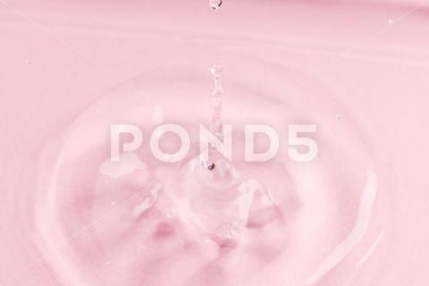 Close up of water drop falling into water with ripples and copy space on pink background. Water, liquid and colour concept. No People Close Water Drop Falling Water Ripple Copy Space Pink Background Liquid Colour Concept Drop Splash Abstract Design Background Wet Flow Fluid Closeup Wave Illustration Macro Business Graphic Symbol Isolated Flowing Color Clean Drink Water Falling Copy Space Pink