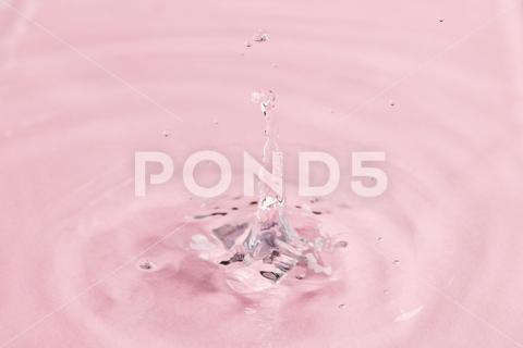 Close up of water drop falling into water with ripples and copy space on pink background. Water, liquid and colour concept. No People Close Water Drop Falling Water Ripple Copy Space Pink Background Liquid Colour Concept Drop Splash Abstract Design Background Wet Flow Fluid Closeup Wave Illustration Macro Business Graphic Symbol Isolated Flowing Color Clean Drink Water Falling Copy Space Pink