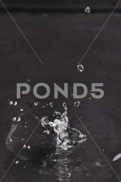 Close up of water drop falling into water with ripples and copy space on black background. Water, liquid and colour concept. No People Close Water Drop Falling Water Ripple Copy Space Black Background Liquid Colour Concept Drop Splash Abstract Design Background Wet Flow Fluid Closeup Illustration Wave Macro Business Graphic Symbol Flowing Isolated Color Drink Clean Water Falling Copy Space Black