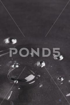 Close up of water drop falling into water with ripples and copy space on black background. Water, liquid and colour concept. No People Close Water Drop Falling Water Ripple Copy Space Black Background Liquid Colour Concept Drop Splash Abstract Design Background Wet Flow Fluid Closeup Illustration Wave Macro Business Graphic Symbol Flowing Isolated Color Drink Clean Water Falling Copy Space Black