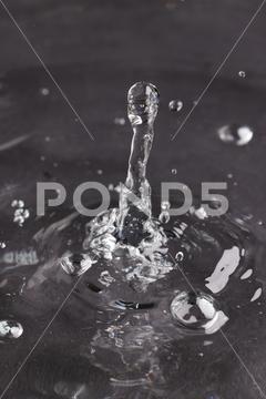 Close up of water drop falling into water with ripples and copy space on black background. Water, liquid and colour concept. No People Close Water Drop Falling Water Ripple Copy Space Black Background Liquid Colour Concept Drop Splash Abstract Design Background Wet Flow Fluid Closeup Illustration Wave Macro Business Graphic Symbol Flowing Isolated Color Drink Clean Water Falling Copy Space Black