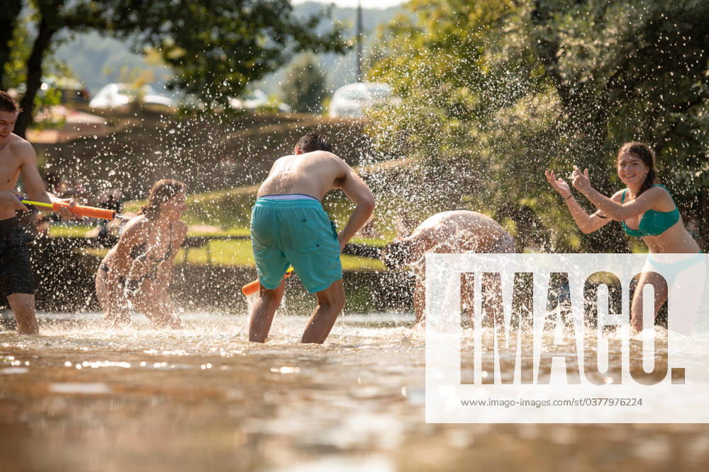 Summer joy friends having fun on river summer joy group of happy friends having fun while running and splashing on river ,model released, Symbolfoto