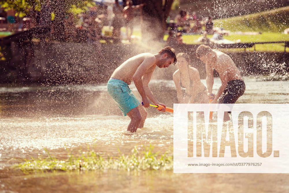 Summer joy friends having fun on river summer joy group of happy friends having fun while running and splashing on river ,model released, Symbolfoto