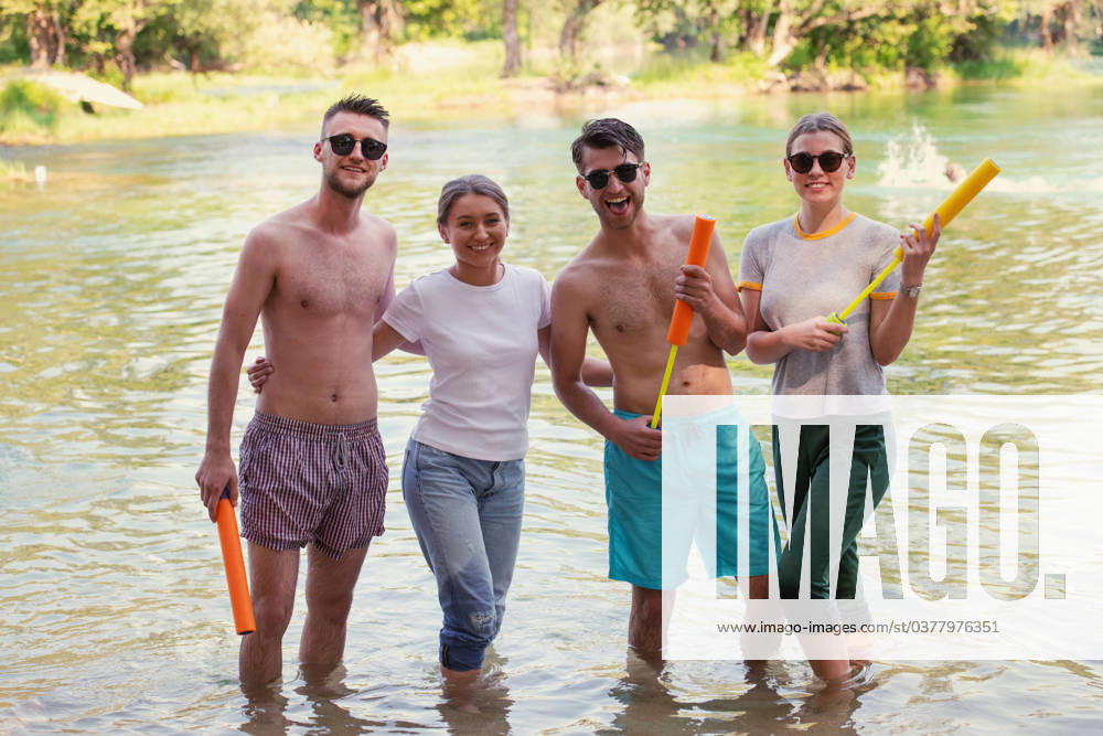 Summer joy friends having fun on river summer joy group of happy friends having fun while running and splashing on river ,model released, Symbolfoto