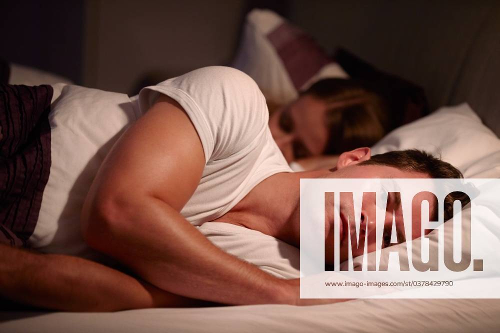 Man Lying Awake In Bed Suffering With Insomnia