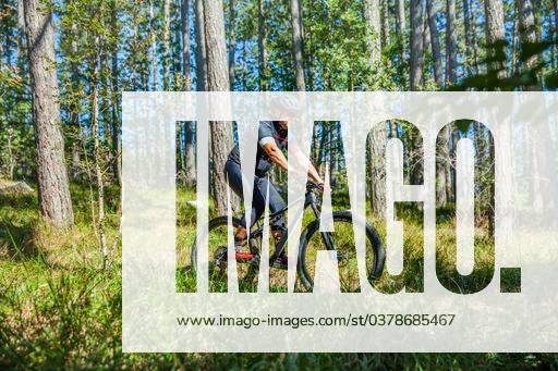 A man riding a bicycle in the forest during daytime 422347 ,model released, Symbolfoto RECORD DATE NOT STATED