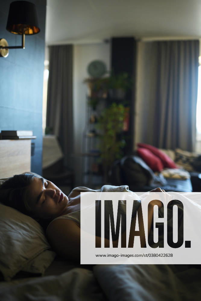 Woman sleeping on bed at home model released, Symbolfoto property released, DSHF01115