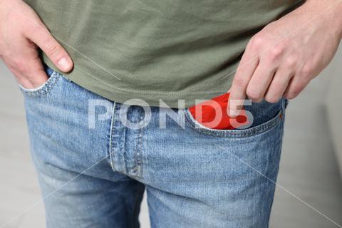 Man pulling condom out of pocket on blurred background, closeup adult aid awareness background blurred care closeup concept condom contraception contraceptive control guy hands health healthcare healthy hiv holding home human illness indoors latex lifestyle male man medical pack package person pocket potency pregnancy prevention protect protection protective pulling red reproduction risk room rubber safe sex sexual venereal virus wrapper