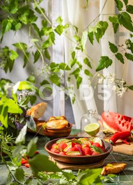 Spicy salad of fresh watermelon balls with basil, lime, rosemary and fennel, topping with olive oil on dark green table surface with sunny light watermelon vegetable summer food healthy salad basil lime rosemary freshness delicious cheese melon table organic epicure vegetarian plate fruit dinner meal sweet green diet red lunch fresh leaf juicy ripe snack herb closeup rustic overhead nourishment eating dish cookery