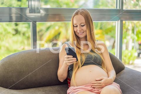 Mobile pregnancy online maternity application. Pregnant mother using phone. Pregnancy, medicine, pharmaceutics, health care and people concept. pregnant online pregnancy mother application woman app young technology maternity mobile cellphone phone internet beautiful belly expecting expectant home smartphone person abdomen connection motherhood communication anticipation sitting bed african american maternal millennial indoors free space goods tummy smiling prenatal bedroom advertisement childbirth parenthood awaiting computer empty space website parent cheerful
