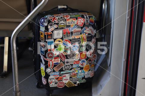 Passenger suitcases containing stickers are placed in the train cabin. Traveler who likes collecting stickers while traveling. Yogyakarta - Indonesia, 09 03 2023; tourism sticker object stickeres indoors ancient memo grunge symbol backgrounds airplane label car trunk hippie nostalgia stick stickers travelling aboard country travel shirt clothes retro leisure camera vacation tourist holiday concept baggage full clothing vintage background adventure voyage handle journey suitcase case luggage trip bag fashion accessory lifestyle business elegant human