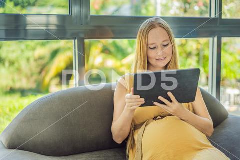 Mobile pregnancy online maternity application. Pregnant mother using phone. Pregnancy, medicine, pharmaceutics, health care and people concept. pregnant online pregnancy mother application woman app young technology maternity mobile cellphone phone internet beautiful belly expecting expectant home smartphone person abdomen connection motherhood communication anticipation sitting care morning bedroom smiling millennial tummy hand tablet programm african website photography template advertisement list blank reading concept indoors holding