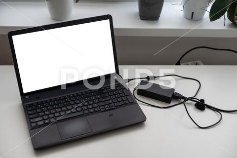 Image of charging a laptop. High quality photo business computer laptop screen technology white bright business image business item cable charge code connection copy space data digital digital device digital equipment electricity energy floor flooring image internet surfing investigate keyboard lifestyle maintenance no person outlet plug power room seek shooting side business still life studio shot terminal the internet unmanned white background white space work remotely background desk display empty flower