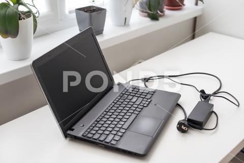 Image of charging a laptop. High quality photo business computer laptop screen technology white bright business image business item cable charge code connection copy space data digital digital device digital equipment electricity energy floor flooring image internet surfing investigate keyboard lifestyle maintenance no person outlet plug power room seek shooting side business still life studio shot terminal the internet unmanned white background white space work remotely background desk display empty flower
