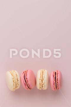 Macaroons on pink background, colorful french cookies pattern. Gift for 8 March, International Women's Day, Valentine Day. Vertical banner with copyspace macaroon traditional macaron sweet cookie confectionery biscuit french colorful pastry macaroons snack chocolate tasty pastel cream background sugar assortment food dessert cake bakery closeup delicious pink candy color green white top yellow french macaroons falling pastel colored coffee delicate lemon overhead vanilla confection delicious macaroon macarons colourful pattern banner