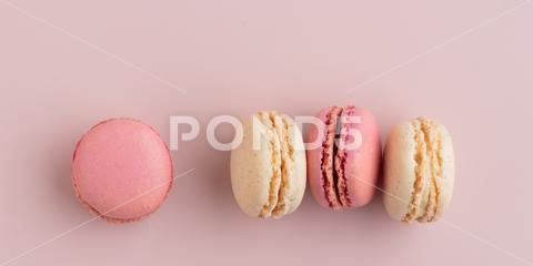 Macaroons on pink background, colorful french cookies pattern. Gift for 8 March, International Women's Day, Valentine Day. Horizontal banner with copyspace macaroon traditional macaron sweet cookie confectionery biscuit french colorful pastry macaroons snack chocolate tasty pastel cream background sugar assortment food dessert cake bakery closeup delicious pink candy color green white top yellow french macaroons falling pastel colored coffee delicate lemon overhead vanilla confection delicious macaroon macarons colourful pattern banner