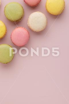 Macaroons on pink background, colorful french cookies pattern. Gift for 8 March, International Women's Day, Valentine Day. Vertical banner with copyspace macaroon traditional macaron sweet cookie confectionery biscuit french colorful pastry macaroons snack chocolate tasty pastel cream background sugar assortment food dessert cake bakery closeup delicious pink candy color green white top yellow french macaroons falling pastel colored coffee delicate lemon overhead vanilla confection delicious macaroon macarons colourful pattern banner
