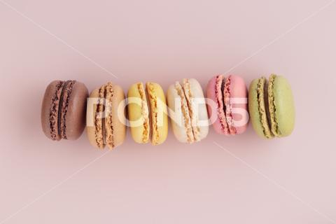 Macaroons on pink background, colorful french cookies pattern. Gift for 8 March, International Women's Day, Valentine Day. Horizontal banner with copyspace macaroon traditional macaron sweet cookie confectionery biscuit french pastry snack tasty cream sugar assortment dessert bakery colorful pink candy delicious color green cake white food background pastel yellow french macaroons falling macaroons pastel colored closeup coffee delicate chocolate lemon overhead vanilla confection delicious macaroon top macarons colourful pattern