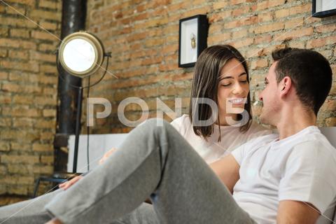Romantic young couple looking each other while relaxing on bed at home woman man couple adult young caucasian two person morning lifestyle indoors home looking 25-30 years millenial casual clothing leisure activity brown hair everyday life heterosexual couple girlfriend love care romance boyfriend domestic bedroom kiss kissing two people male female caucasian ethnicity 21-25 years old 0-6 month old