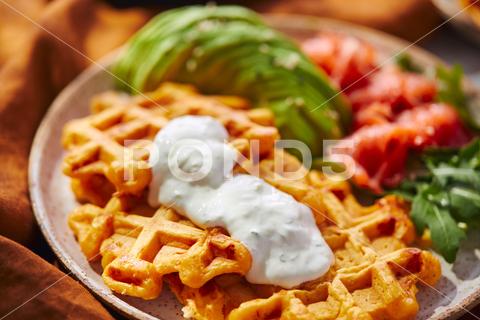 Hearty sweet potato or pumpkin waffles with avocado, salmon, arugula and sauce waffle salmon sweet potato pumpkin breakfast avocado healthy food delicious meal dinner lunch tasty fish morning dish snack homemade diet plate fresh green vegetable brunch cooking background gourmet salad smoked baked epicure bread toast sauce belgian healthy breakfast wafer fat eating organic fast food nourishment smoked salmon herb belgian waffles ketogenic arugula