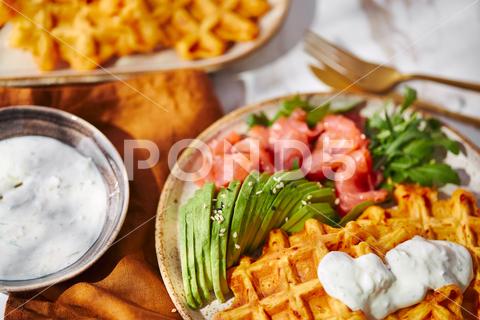 Hearty sweet potato or pumpkin waffles with avocado, salmon, arugula and sauce waffle salmon sweet potato pumpkin breakfast avocado healthy food delicious meal dinner lunch tasty fish morning dish snack homemade diet plate fresh green vegetable brunch cooking background gourmet salad smoked baked epicure bread toast sauce belgian healthy breakfast wafer fat eating organic fast food nourishment smoked salmon herb belgian waffles ketogenic arugula