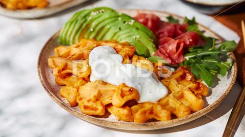 Hearty sweet potato or pumpkin waffles with avocado, salmon, arugula and sauce waffle salmon sweet potato pumpkin breakfast avocado healthy food delicious meal dinner lunch tasty fish morning dish snack homemade diet plate fresh green vegetable brunch cooking background gourmet salad smoked baked epicure bread toast sauce belgian healthy breakfast wafer fat eating organic fast food nourishment smoked salmon herb belgian waffles ketogenic arugula