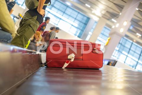 The luggage belt with suitcases being delivered to the passengers at the arrival terminal adventure air travel airport arrival background bag baggage belt blur blurred building business carousel cart city claim design domestic equipment holidays industrial industry interior international luggage modern problem protest public service staff strike terminal tourism transfer transit transport transportation trip trolley waiting work