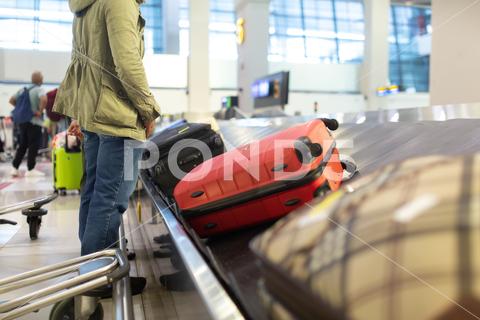 The luggage belt with suitcases being delivered to the passengers at the arrival terminal adventure air travel airport arrival background bag baggage belt blur blurred building business carousel cart city claim design domestic equipment holidays industrial industry interior international luggage modern problem protest public service staff strike terminal tourism transfer transit transport transportation trip trolley waiting work