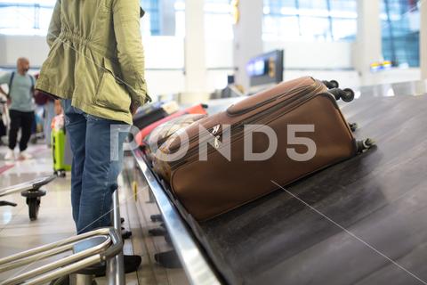 The luggage belt with suitcases being delivered to the passengers at the arrival terminal adventure air travel airport arrival background bag baggage belt blur blurred building business carousel cart city claim design domestic equipment holidays industrial industry interior international luggage modern problem protest public service staff strike terminal tourism transfer transit transport transportation trip trolley waiting work