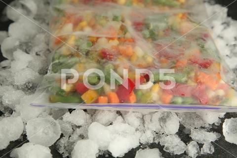 Zip bag with different frozen vegetables and ice on table, closeup asparagus assortment background bag carrot closeup cold cooking corn cut delicious diet different eating food freeze freezer freezing fresh frost frozen grey health healthy homemade ice ingredient kitchen meal mix mixed natural nutrition object organic peas pepper product raw storage table tasty various vegan vegetable vegetables vegetarian vitamin zip