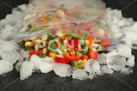 Zip bag with different frozen vegetables and ice on grey table, closeup asparagus assortment background bag carrot closeup cold cooking corn cut delicious diet different eating food freeze freezer freezing fresh frost frozen grey health healthy homemade ice ingredient kitchen meal mix mixed natural nutrition object organic peas pepper product raw storage table tasty various vegan vegetable vegetables vegetarian vitamin zip