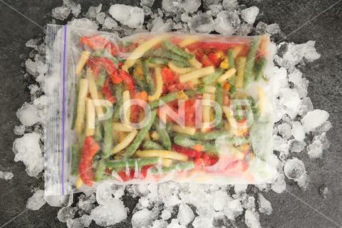 Zip bag with different frozen vegetables and ice on grey table, top view asparagus assortment background bag carrot cold cooking corn cut delicious diet different eating flat food freeze freezer freezing fresh frost frozen grey health healthy homemade ice ingredient kitchen lay meal mix mixed natural nutrition object organic pepper product raw storage table tasty top various vegan vegetables vegetarian view vitamin zip