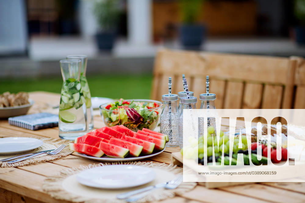 Dining table set for dinner on the terrace in summer, garden party concept. A dining table set for dinner on the terrace in summer, garden party concept. model released