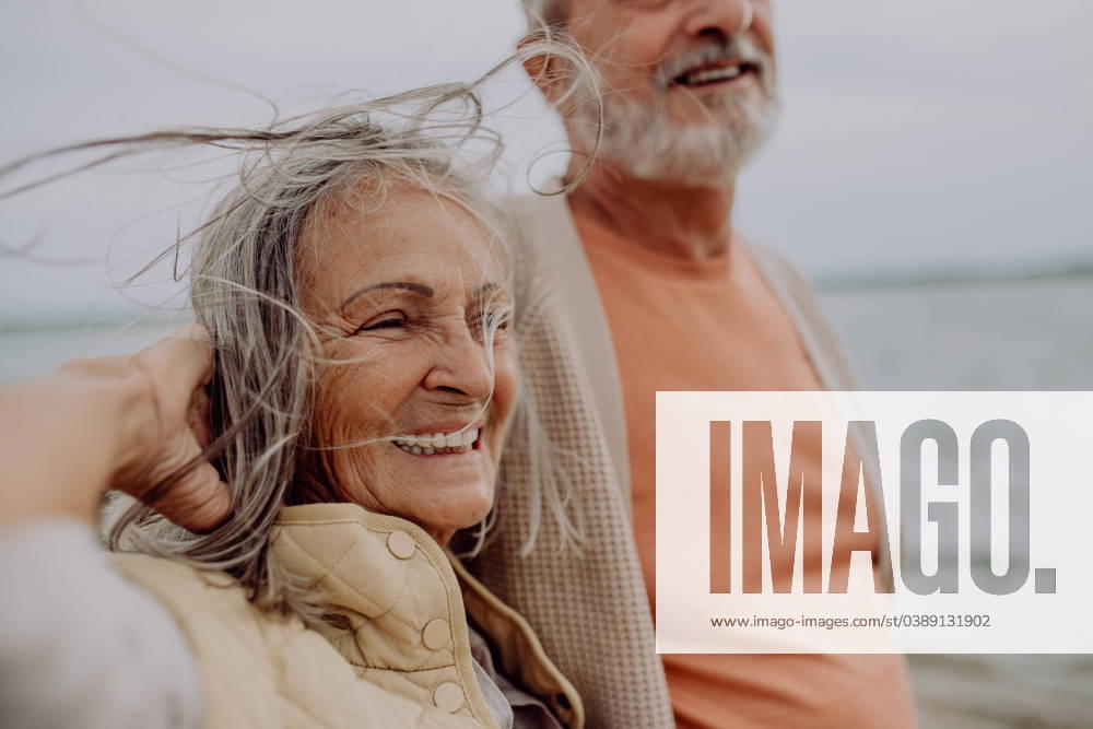 Happy senior couple relaxing and having romantic moment near the autumn sea. Happy senior couple relaxing and having romantic moment at the autumn sea. model released