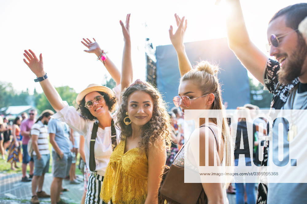 Front view portrait of group of young friends dancing at summer festival. A front view portrait of group of young friends dancing at summer festival. model released