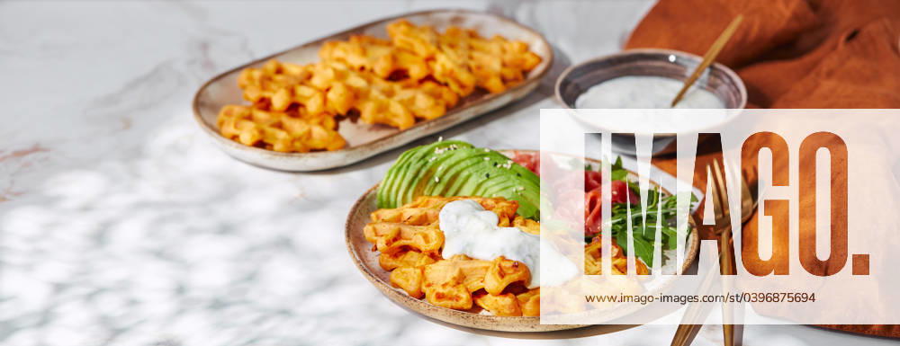 Hearty sweet potato or pumpkin waffles with avocado, salmon, arugula and sauce Hearty sweet potato or pumpkin waffles with avocado, salmon, arugula and sauce