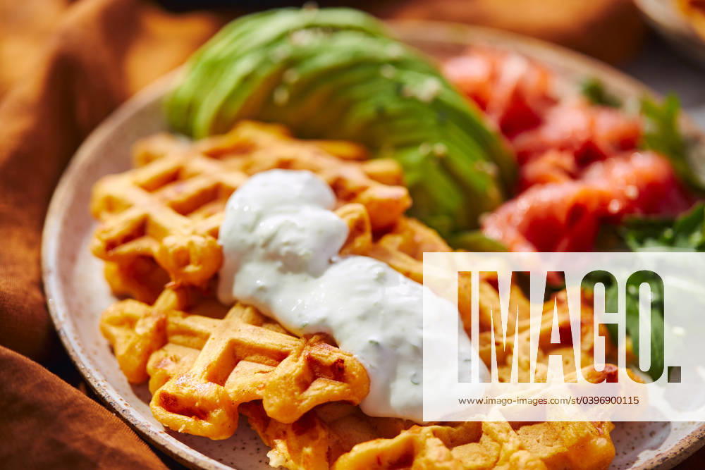 Hearty sweet potato or pumpkin waffles with avocado, salmon, arugula and sauce Hearty sweet potato or pumpkin waffles with avocado, salmon, arugula and sauce
