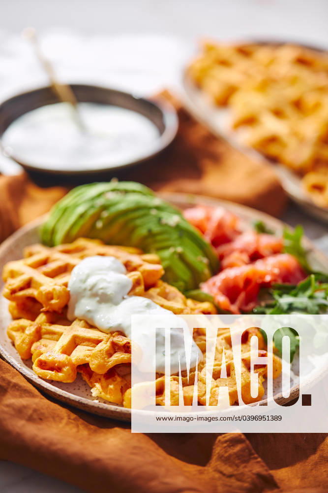 Hearty sweet potato or pumpkin waffles with avocado, salmon, arugula and sauce Hearty sweet potato or pumpkin waffles with avocado, salmon, arugula and sauce
